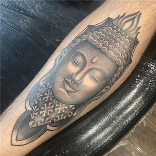 ornate buddha geometric black-and grey shin tattoo