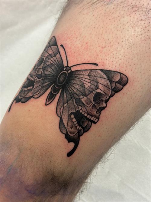 skull butterfly neotraditional black and grey stippling dotwork pepper shading thigh tattoo